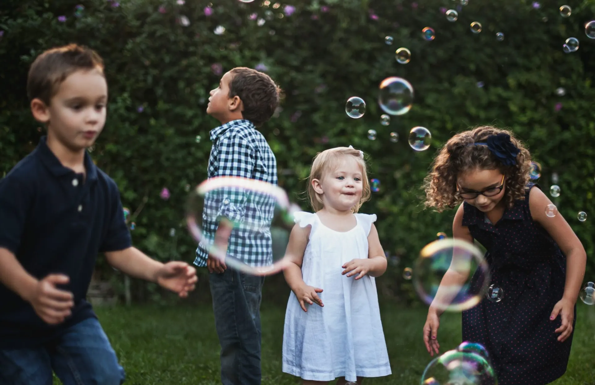 Children playing with bubbles outdoors